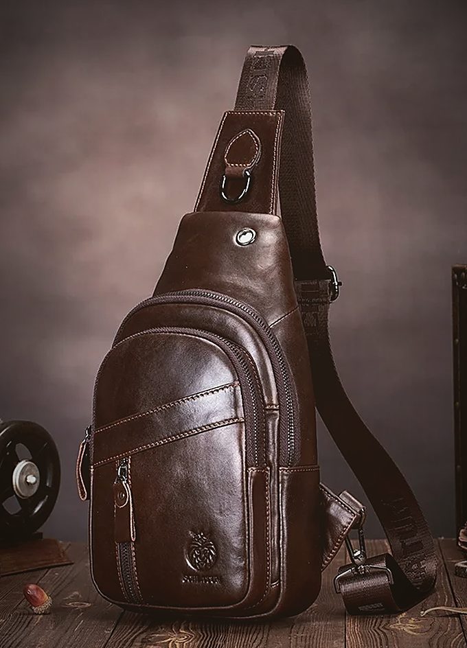 A brown leather one-strap sling bag